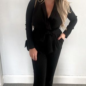 Black jumpsuit with tie at waist and v neck